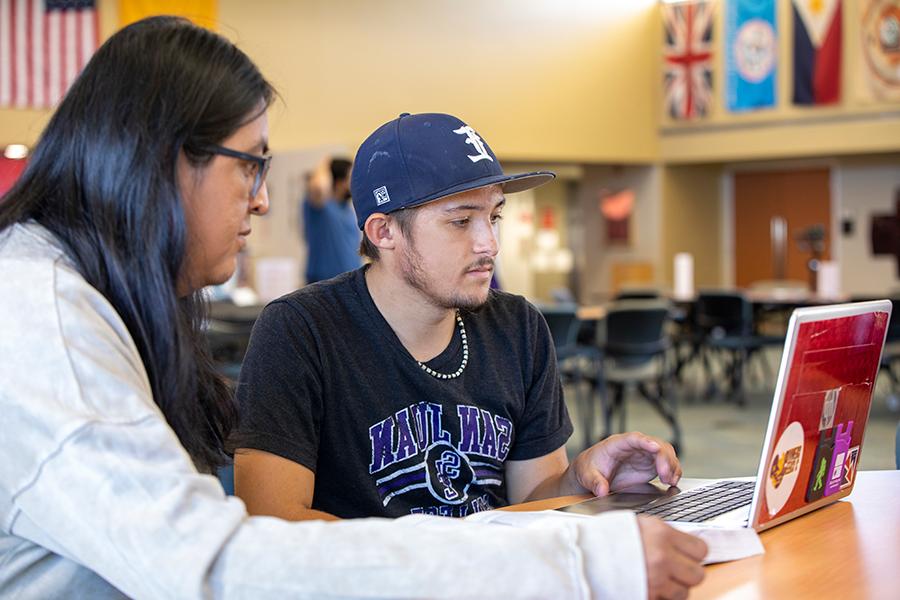 Two students working on a computer